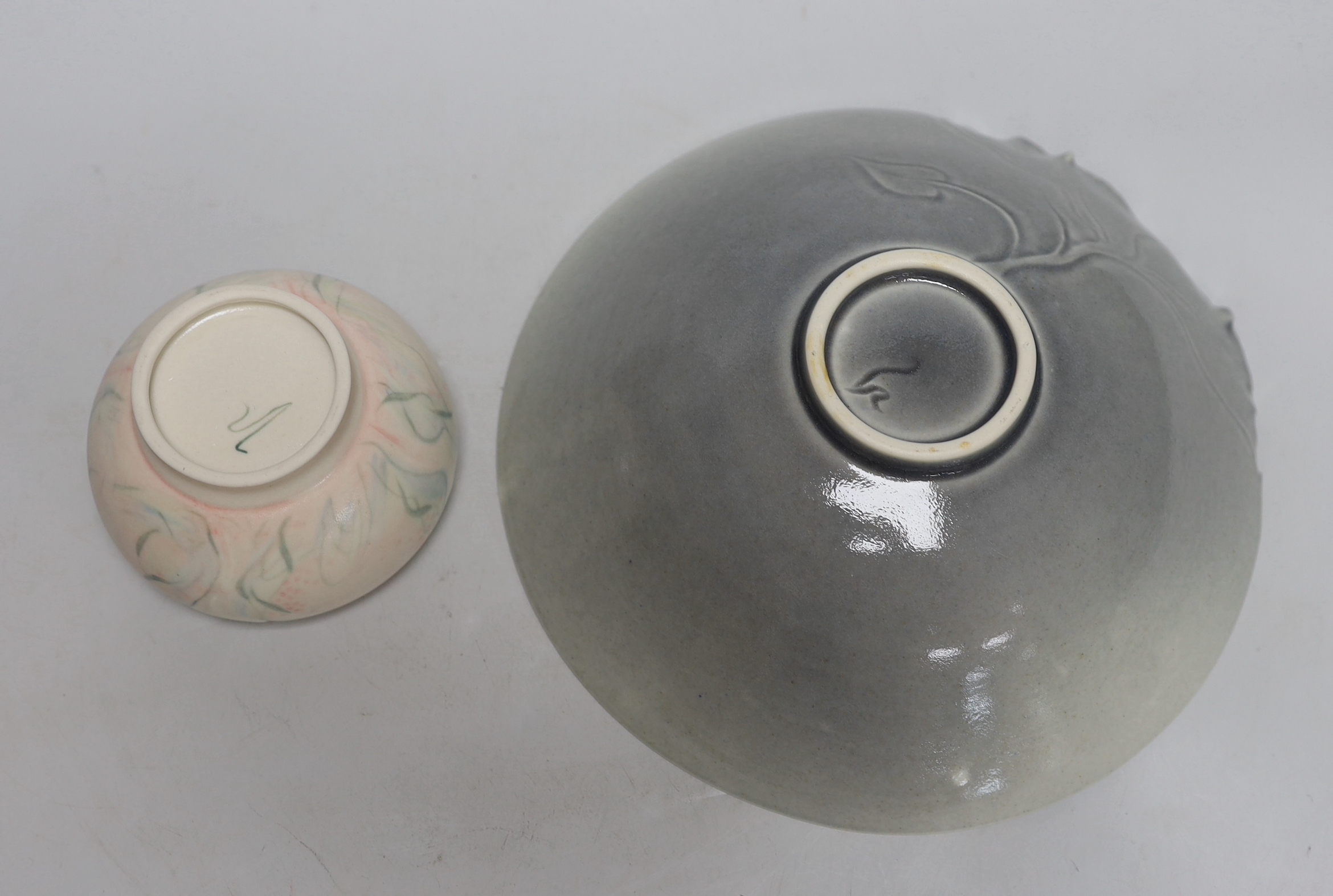 Three hand thrown and carved stoneware pieces by one maker purchased at Water Perry, Oxford, each signed to the base, the largest 23cm in diameter